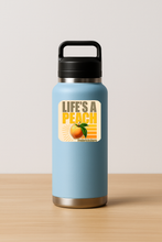 Load image into Gallery viewer, Life's A Peach Sticker featuring bold retro design
